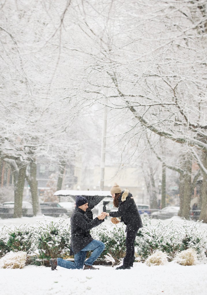 Wyatt proposing to Jenna on one knee in a snowy park